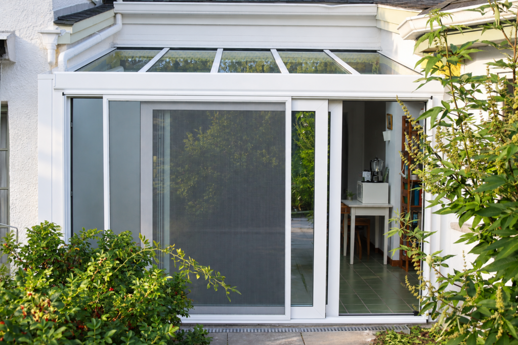 Panoramic sliding glass door installed in a Verona sunroom